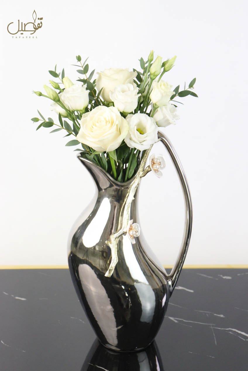 Pitcher-shaped vase styled with fresh white flowers