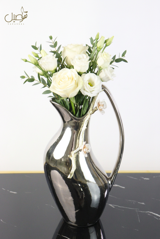 Pitcher-shaped vase styled with fresh white flowers